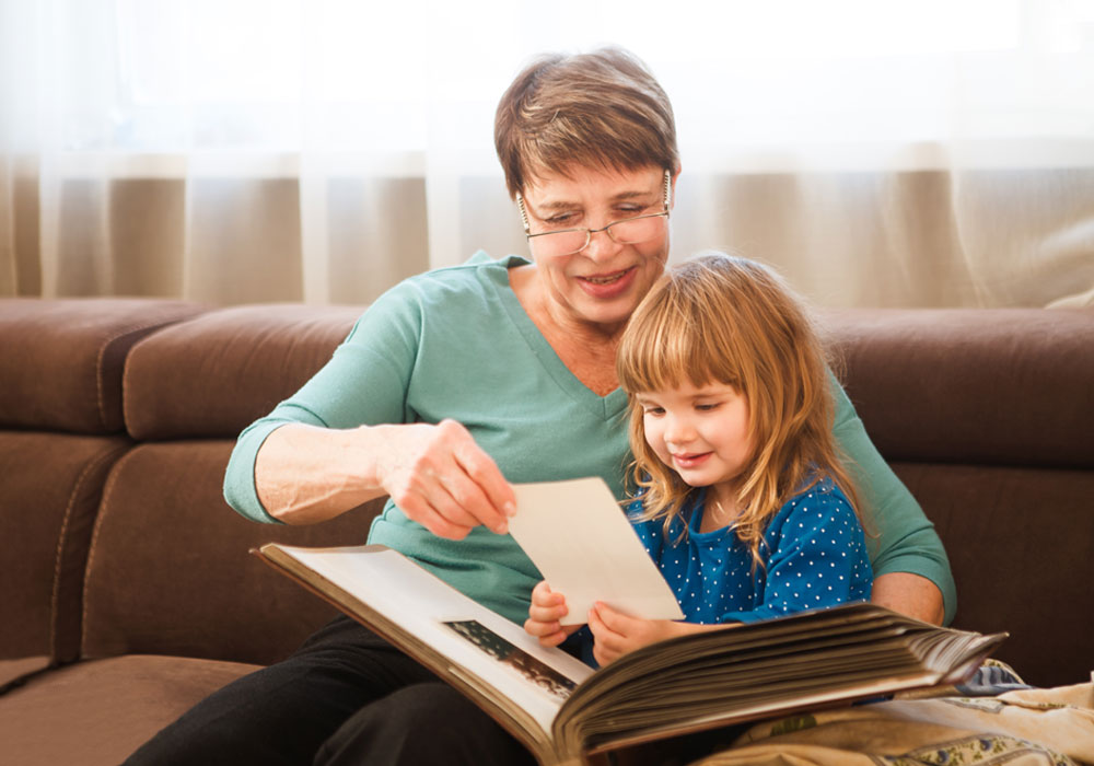 adult reading and showing a book to a child 