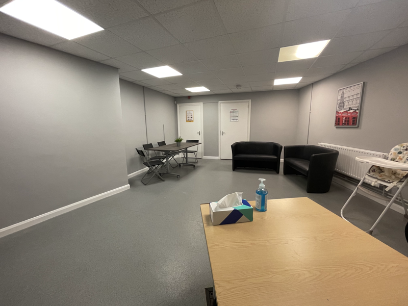 room with sofas, table and chairs 