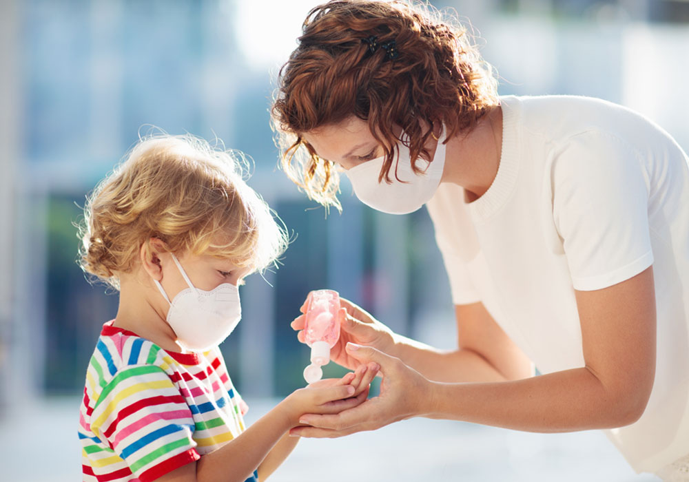 adult and child interacting with masks covering their faces 